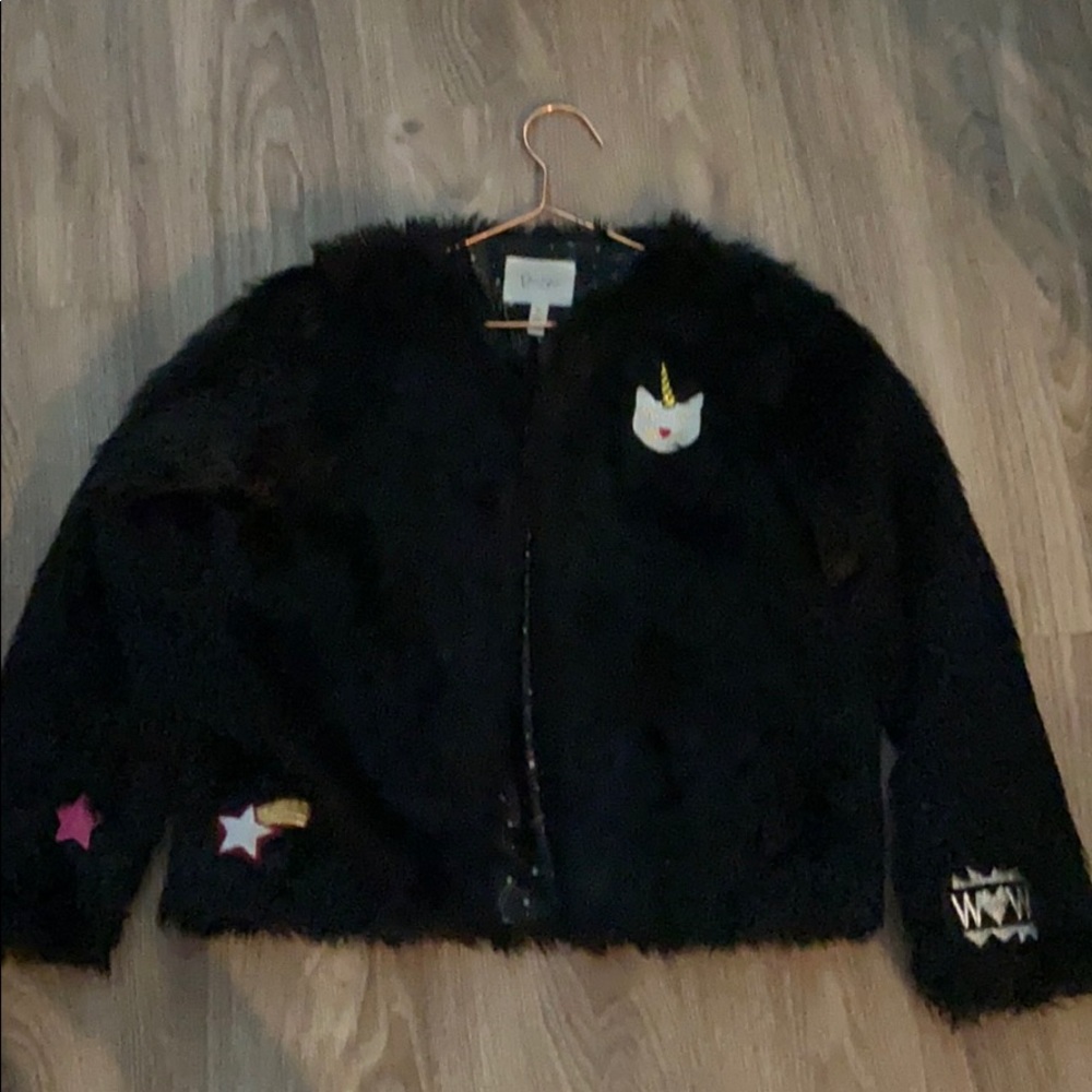 A teddy jacket with patches on it